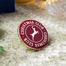 Christmas club - text with a reindeer image on a round pin badge