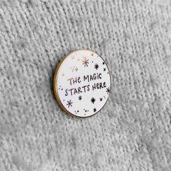 The magic starts here - text on white circle - Christmas pin badge